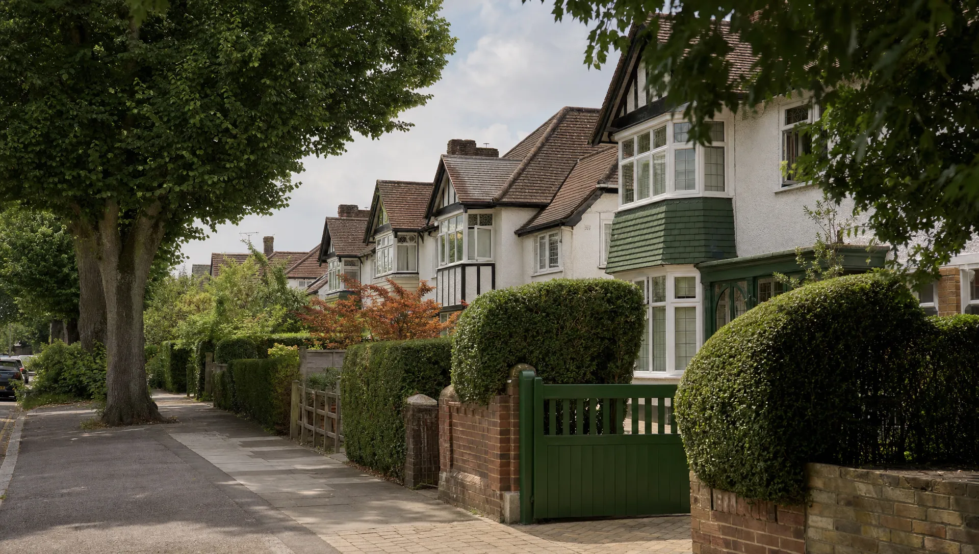 A tree-lined Ickenham street with 1930s semis, mature hedges, front gardens and driveways sets the scene for sales and lettings.